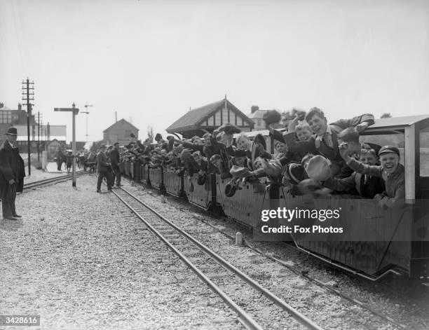 Crowd of excited travellers on the Romney, Hythe and Dymchurch Light Railway in Kent, the smallest public train system in the world. The train...