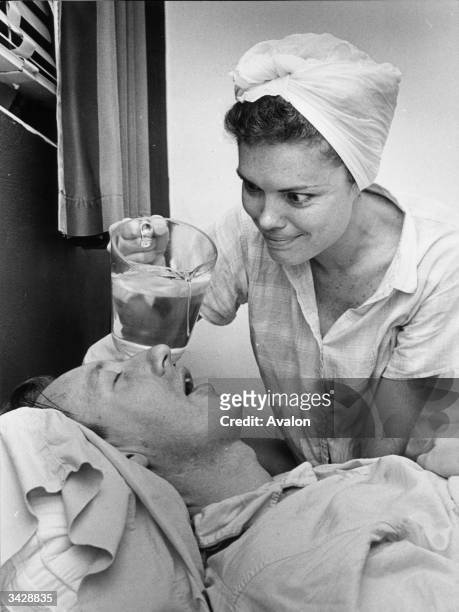 Denise Strenglein of St Petersburg, Florida tries dripping water into her husband Harry's mouth to stop him snoring.