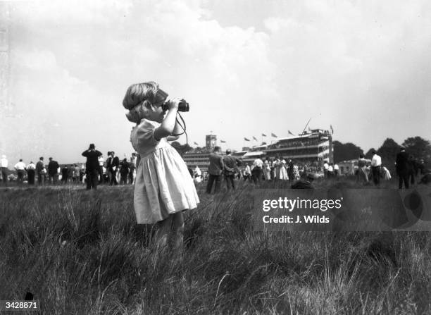 Two year old Pamela Brown watching the racing during the first day of the Royal Ascot races.