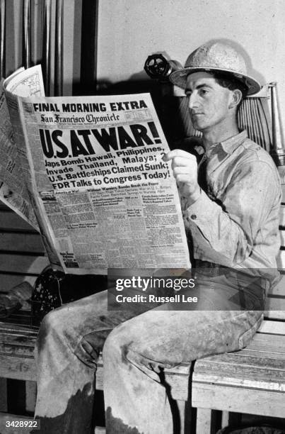 Man reading an account of the bombing of Pearl Harbour in the San Francisco Chronicle at the Shasta Dam in California.