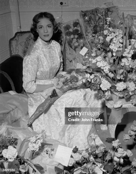 After a successful first night as Eliza Doolittle in the musical, 'My Fair Lady' Julie Andrews is surrounded by flowers in her dressing room, the...