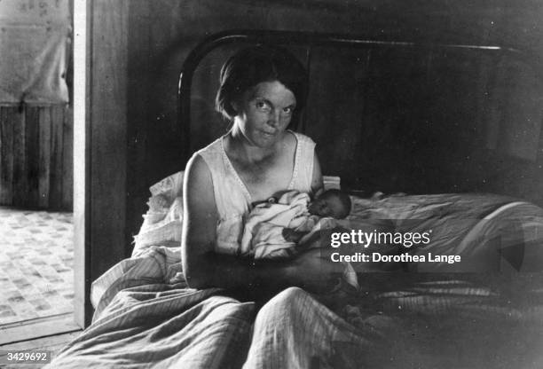 Sharecropper's wife and her youngest child at home, near Cleveland, Mississippi.