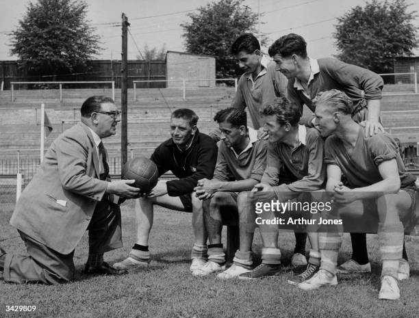 Neil McBain, the manager of Watford FC, talking to a group of players who have just joined the club, Charles Billington, Tony Collins, Michael...