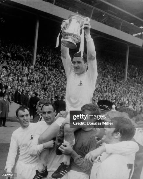 Dave Mackay, the captain of Tottenham Hotspur, celebrating with his teammates Jimmy Greaves, Alan Gilzean, Pat Jennings, Terry Venables and Jimmy...