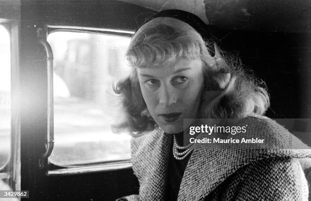 British transgender woman, Roberta Cowell , in a Paris taxi, March 1954. Cowell, a former Spitfire pilot, prisoner-of-war and racing driver, is...