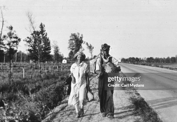 Couple walking along the highway in Crittenden County, Arkansas.