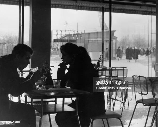 Young couple chatting over a drink at one of Moscow's permanent exhibition centres.