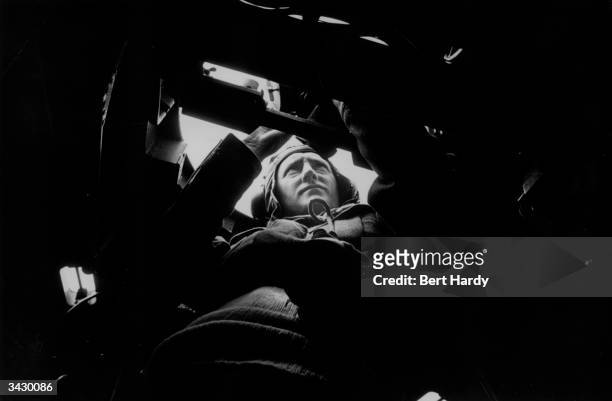 An airman in a Sunderland bomber, which will take part in an exercise attack on the liner 'Queen Elizabeth'. Original Publication: Picture Post -...
