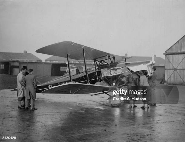 The Prince of Wales' De Havilland Fox Moth cabin aeroplane being inspected on the tarmac at Stag Lane, London.