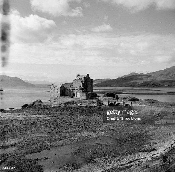 Eilean Donan Castle on Loch Duich in the Western Highlands of Scotland. The distant mountains are the Coolins of Skye, the Isle to which Bonnie...