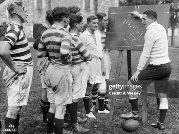 Vivian Gordon James Jenkins, the Welsh Rugby international and Glamorgan County cricketer, discussing rugby tactics with players at Dover College.