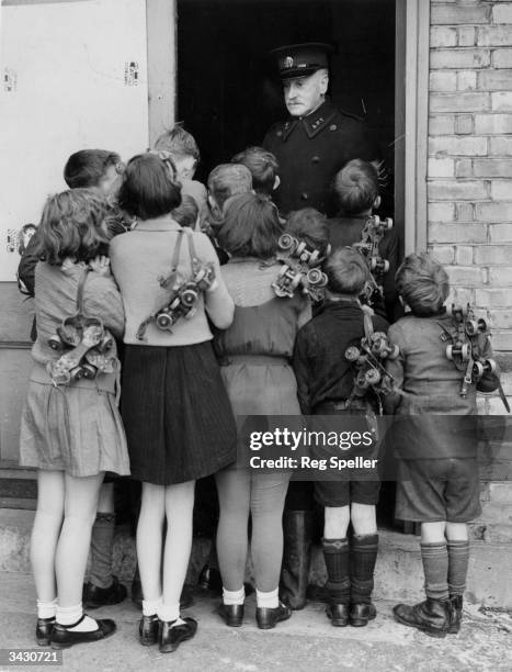 Group of children waiting to get into the rollerskating rink at Alexandra Palace, London.