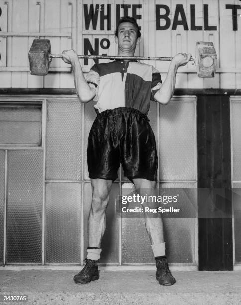 Peter Berry, outside-right for the Crystal Palace football team undergoes weight training at Selhurst Park, south London.