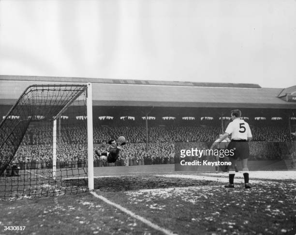 The Fulham goalkeeper making a flying save during a game against Peterborough at Craven Cottage, London.
