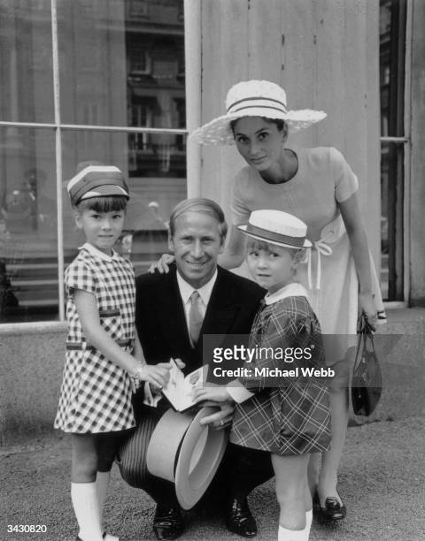 England and Manchester United footballer, Bobby Charlton, with his wife, Norma, and his daughters, Suzanne and Andrea, after receiving his OBE at...