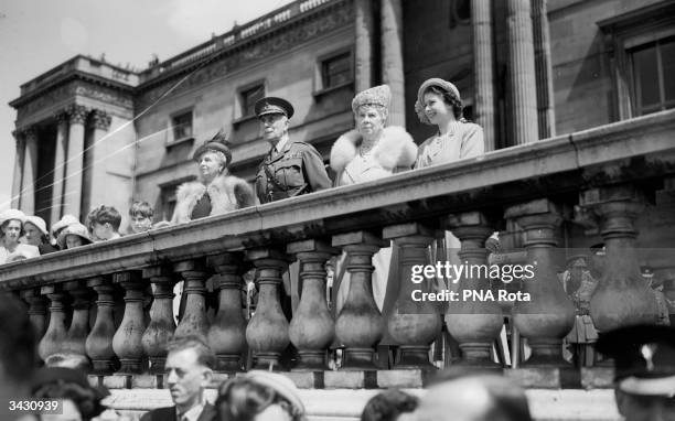 Queen Mary , Princess Elizabeth and the Earl and Countess Alice of Athlone watch the ceremony of the presentation of new colours to the 1st Battalion...