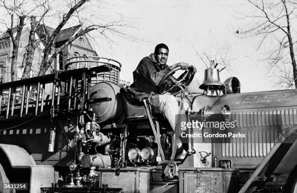 Paul Honesty, a fireman and former American football star at Howard University, behind the wheel of a fire engine in Washington DC.