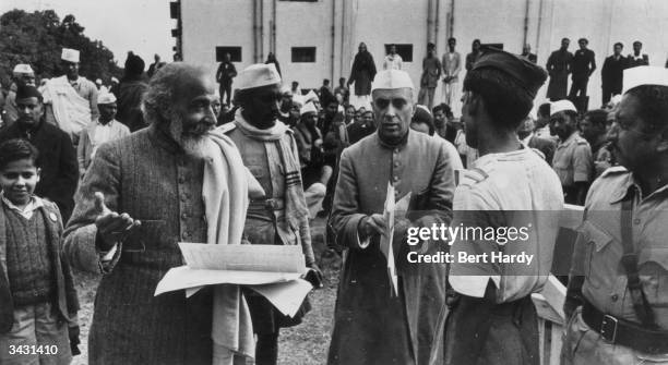 Indian statesman Pandit Jawaharlal Nehru attends a meeting of the Constituent Assembly in the Council House Library, New Delhi, to decide on the...