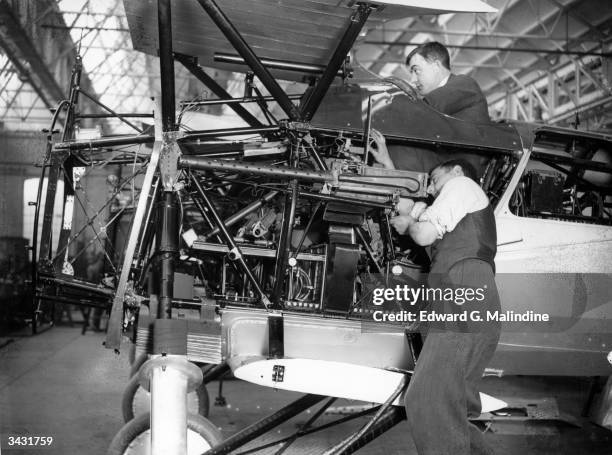 Workers at the Bristol Aeroplane Co works at Filton, Gloucester, fitting controls and calibrating the gun sights of the Bristol Bulldog, an all steel...