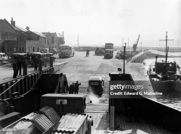 At Yarmouth, Isle of Wight traffic leaves the 'Farringford', British Railways' diesel-electric passenger and car ferry to the island.