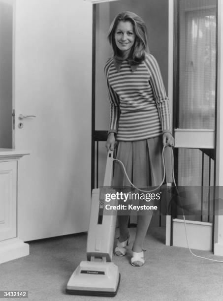 Woman using an Electrolux twin 502 vacuum cleaner.