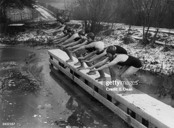 Regulars of the women's pond at Kenwood on Hampstead Heath, London are underterred by the cold, prepare to die into the icy water.