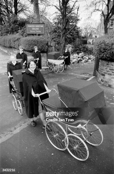 Group of trainee nannies from the Princess Christian College for Nursery Training in Manchester take their young charges out for a walk.