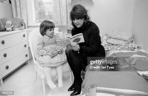 Welsh actress Nerys Hughes reads a Mister Man book to her three-year-old daughter Anne Marie. Nerys is best known for her role as Sandra in the BBC...