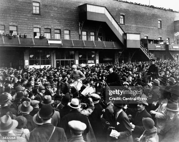 Golden Miller, ridden by Gerry Wilson being led in by owner Dorothy Paget after winning the Grand National at Aintree, near Liverpool.