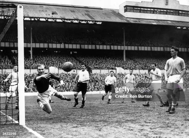 Manchester City's German goalkeeper acrobatically tips the ball around the post from a Tottenham Hotspur shot on goal at White Hart Lane.