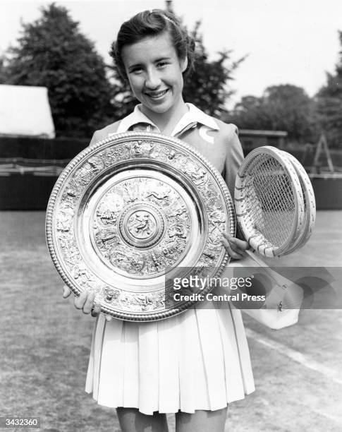 American tennis player Maureen Connolly with the women's singles trophy after beating Doris Hart in the final at the Wimbledon Lawn Tennis...