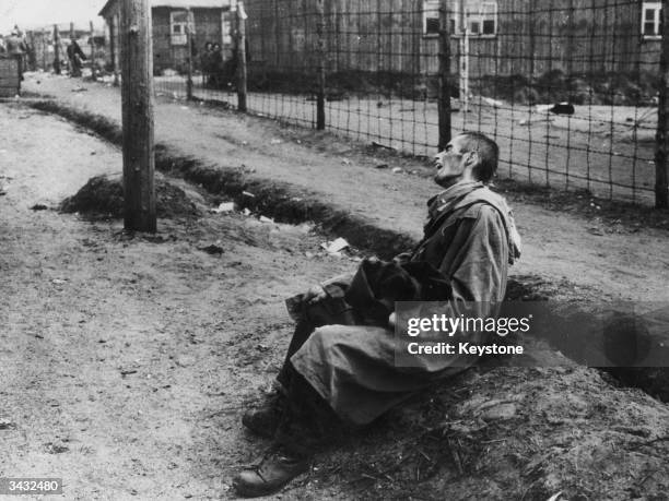 Prisoner in Belsen Concentration Camp is too weak to walk any further, Germany, April, 1945.