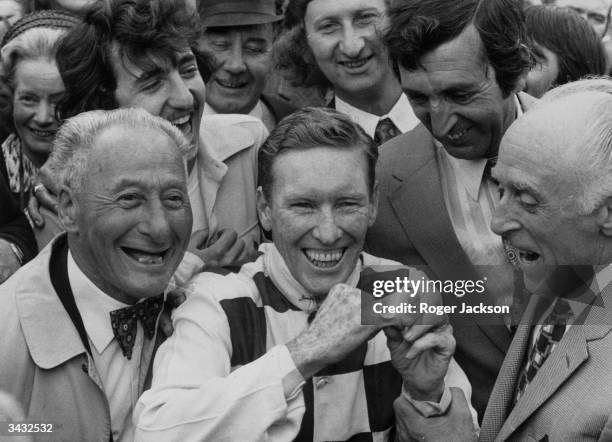 Australian jockey Bill Pyers showing off the ring which he was presented with after winning the King George VI and Queen Elizabeth Stakes at Ascot.