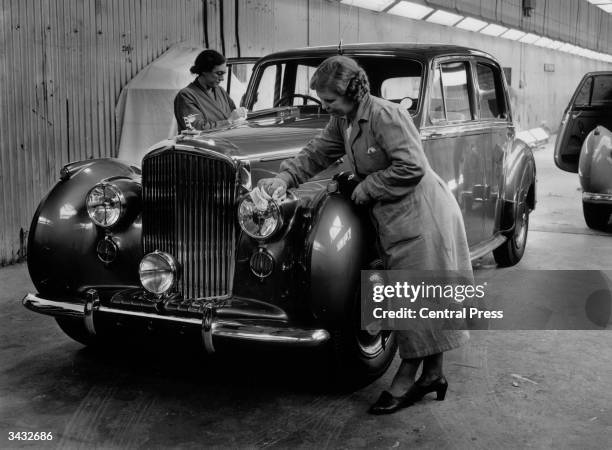 Bentley receiving its final polish from women workers in the despatch bay at the Rolls Royce factory, Crewe.