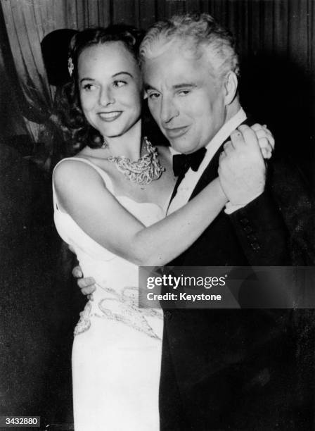 Charlie Chaplin , with his wife the actress Paulette Goddard , at Broadway, New York.