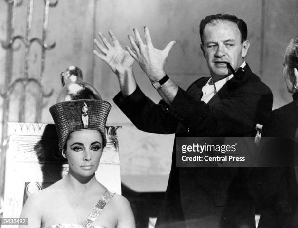 American director Joseph L Mankiewicz discusses Elizabeth Taylor's Egyptian-style headdress with costume designer Irene Sharaff, on the set of the...
