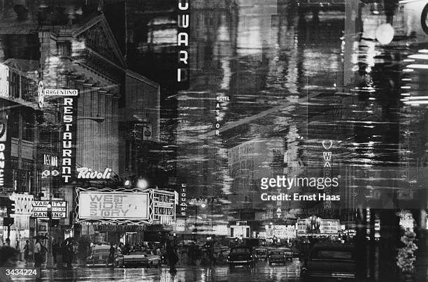 Premium Rates Apply. 1962: Times Square, New York at night time, seen through a window. In black and white book