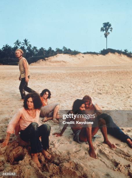 Group of friends relaxing on the beach in Goa, India