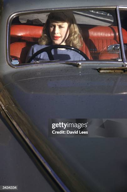 British transgender woman, Roberta Cowell driving her car in the south of France, 1954. Cowell, a former Spitfire pilot, prisoner-of-war and racing...