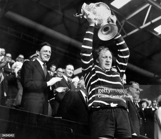Angus Ogilvy, the husband of Princess Alexandra, watching as the captain of Featherstone Rovers celebrates winning the Challenge Cup at Wembley.