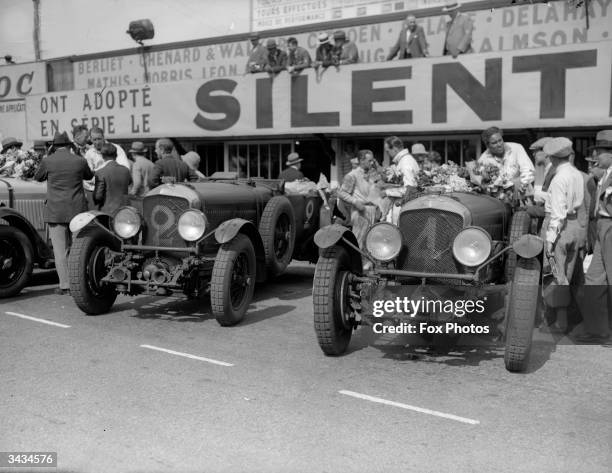 British racing drivers Woolf Barnato and Glen Kidston with their Bentley Motors Ltd Bentley Speed Six in parc ferme alongside the second placed team...