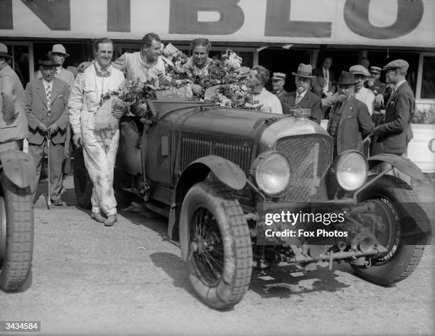 British racing driver "Bentley Boys" Woolf Barnato and Glen Kidston with their Bentley Motors Ltd Bentley Speed Six in parc ferme alongside the...