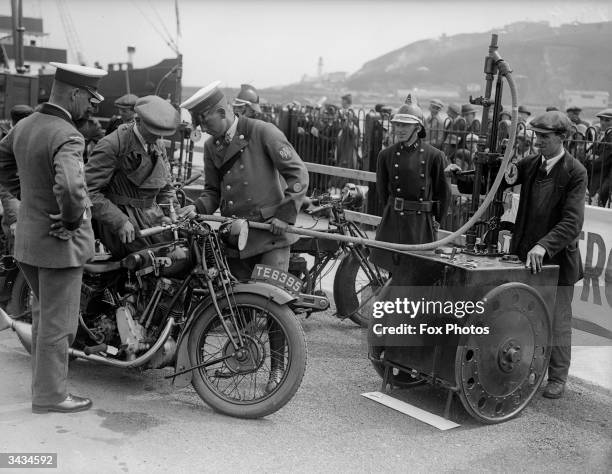 Motorcycle arriving in the Isle of Man for the TT races is attended to on the quayside.