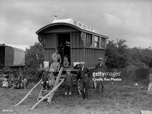 Gypsy family with their caravan parked on Epsom Downs for Derby day.