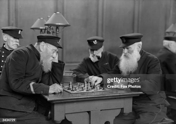 John Landers, a Chelsea Pensioner enjoying a game of chess with fellow Pensioner, B Hutchins.