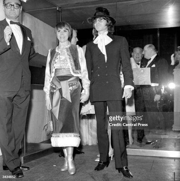 English actress Judy Carne and fiance US photographer Dean Goodhill arriving at the Paramount cinema, Piccadilly Circus, London, for the world...