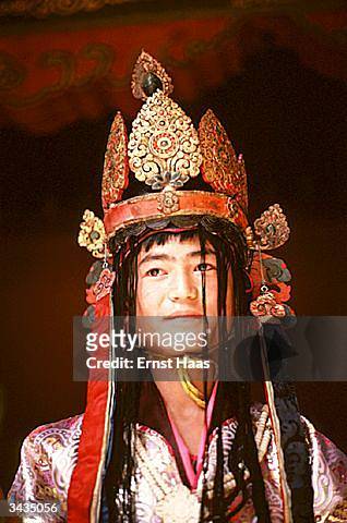 Participant in the coronation festivites of King Jigme Singye Wangchuk of Bhutan wearing an ornate headdress.