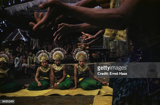 Balinese dancers wearing their intricate headdresses. Colour photography book