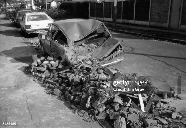 Wrecked car on a London street which has been hit by falling masonry during the hurricane which swept southern England.