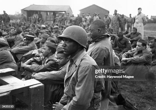 Private Auguster Wells of Tennessee attends a service for black American soldiers serving in Britain during World War II. Original Publication:...